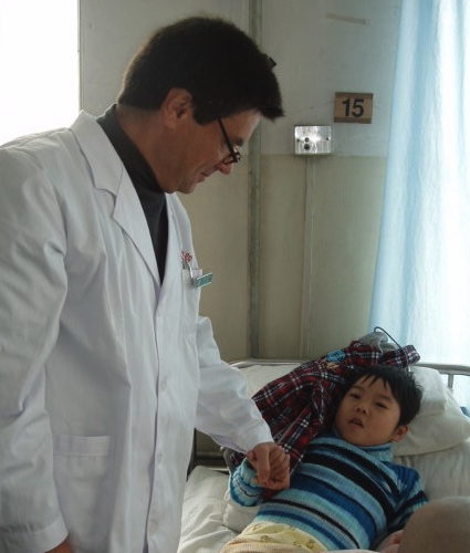 Surgeon holding boy's hand